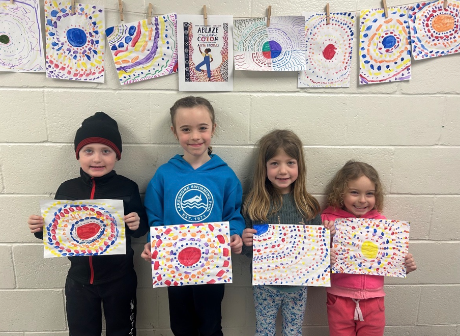 Students Holding Artwork